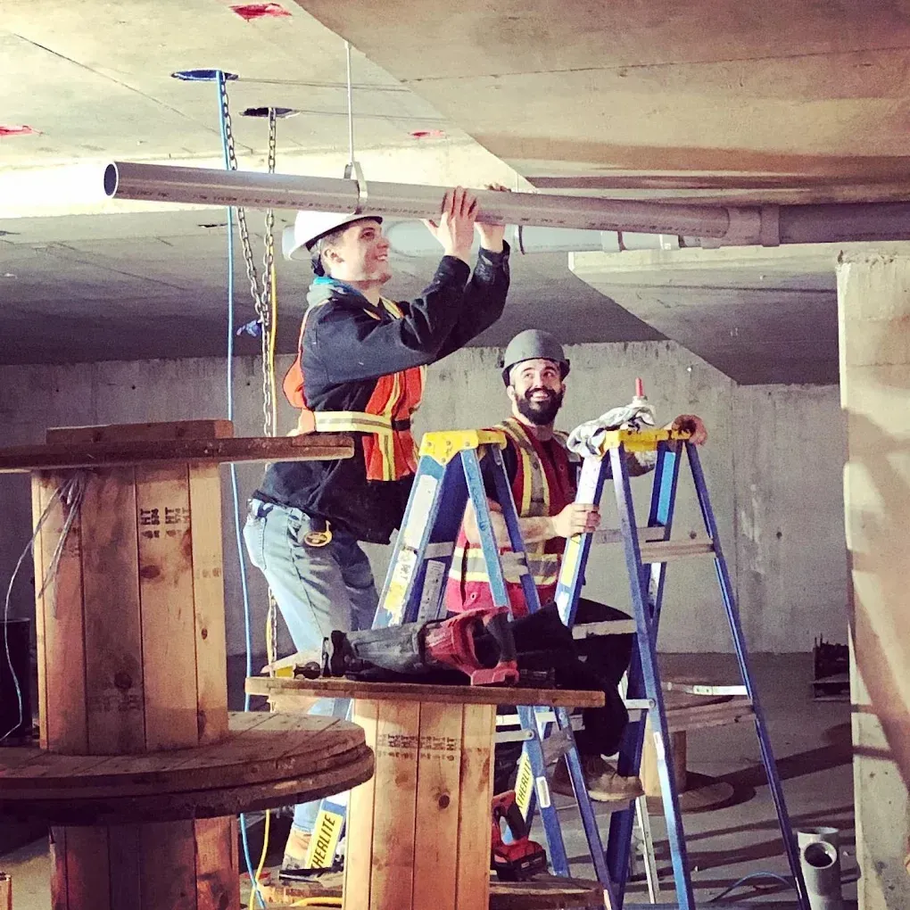 Plumber inspecting pipes for leaks during a spring plumbing inspection